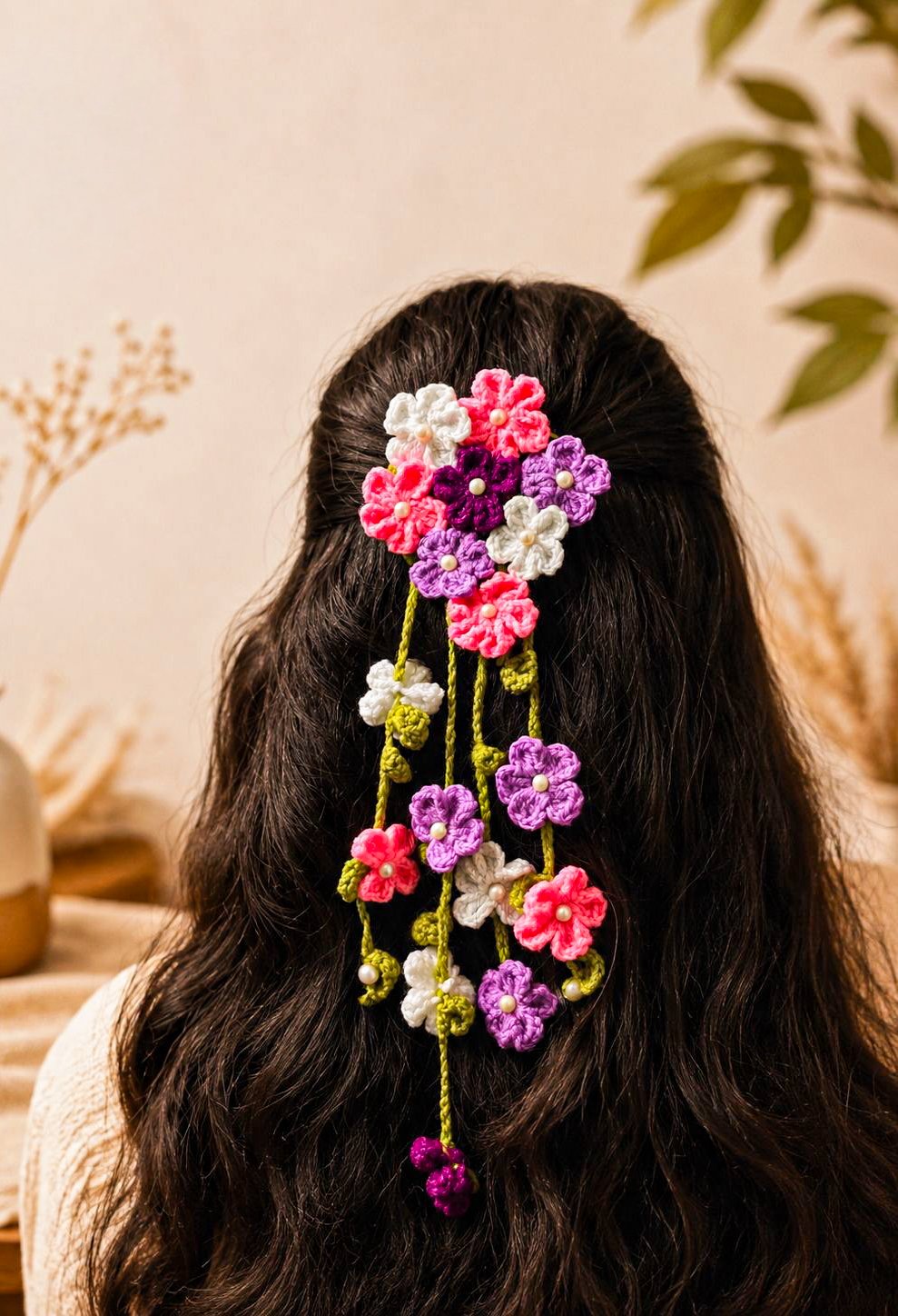 A cascade of hand-crocheted flowers pinned into long hair